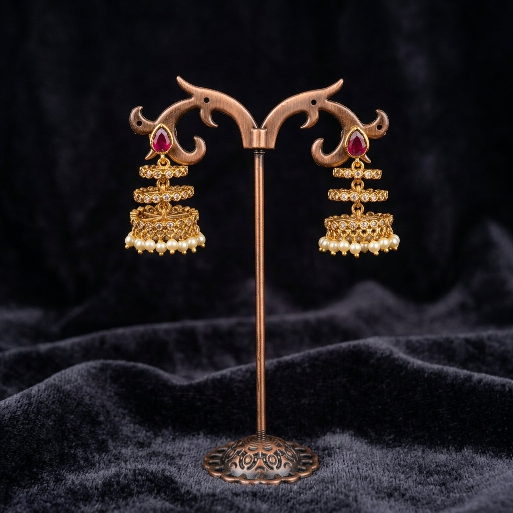 Timeless Ruby Jhumkas - Studio shot featuring luxury jewelry design.